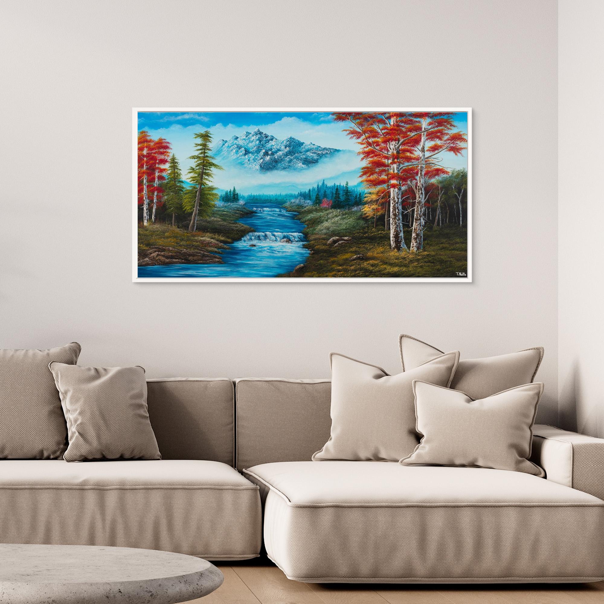 Premium canvas art print showing big mountains and an extensive forest landscape with red trees and a small river with a waterfall, printed on high-quality canvas with vibrant colors, displayed in a modern living room.