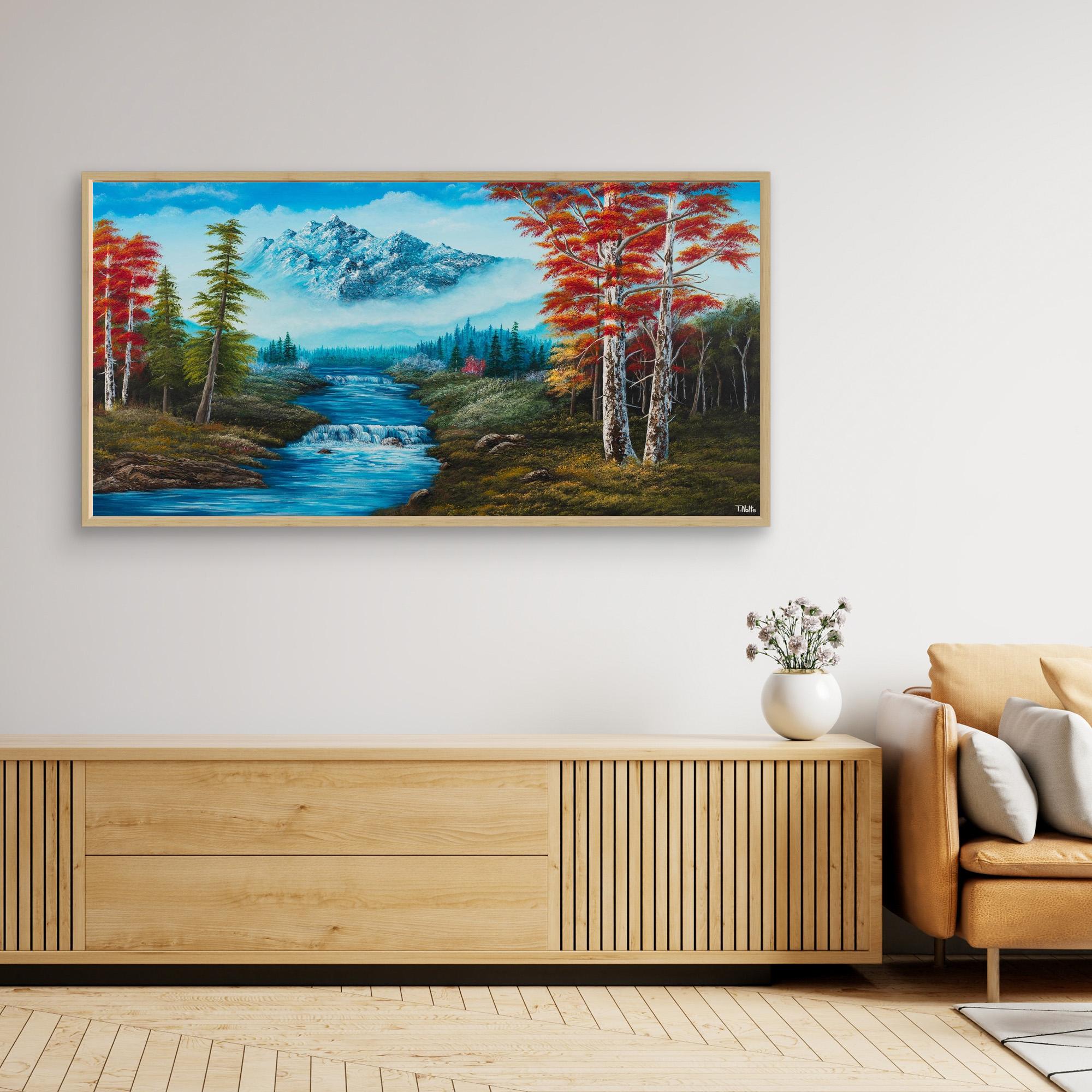 Premium canvas art print showing big mountains and an extensive forest landscape with red trees and a small river with a waterfall, printed on high-quality canvas with vibrant colors, displayed in a modern living room.