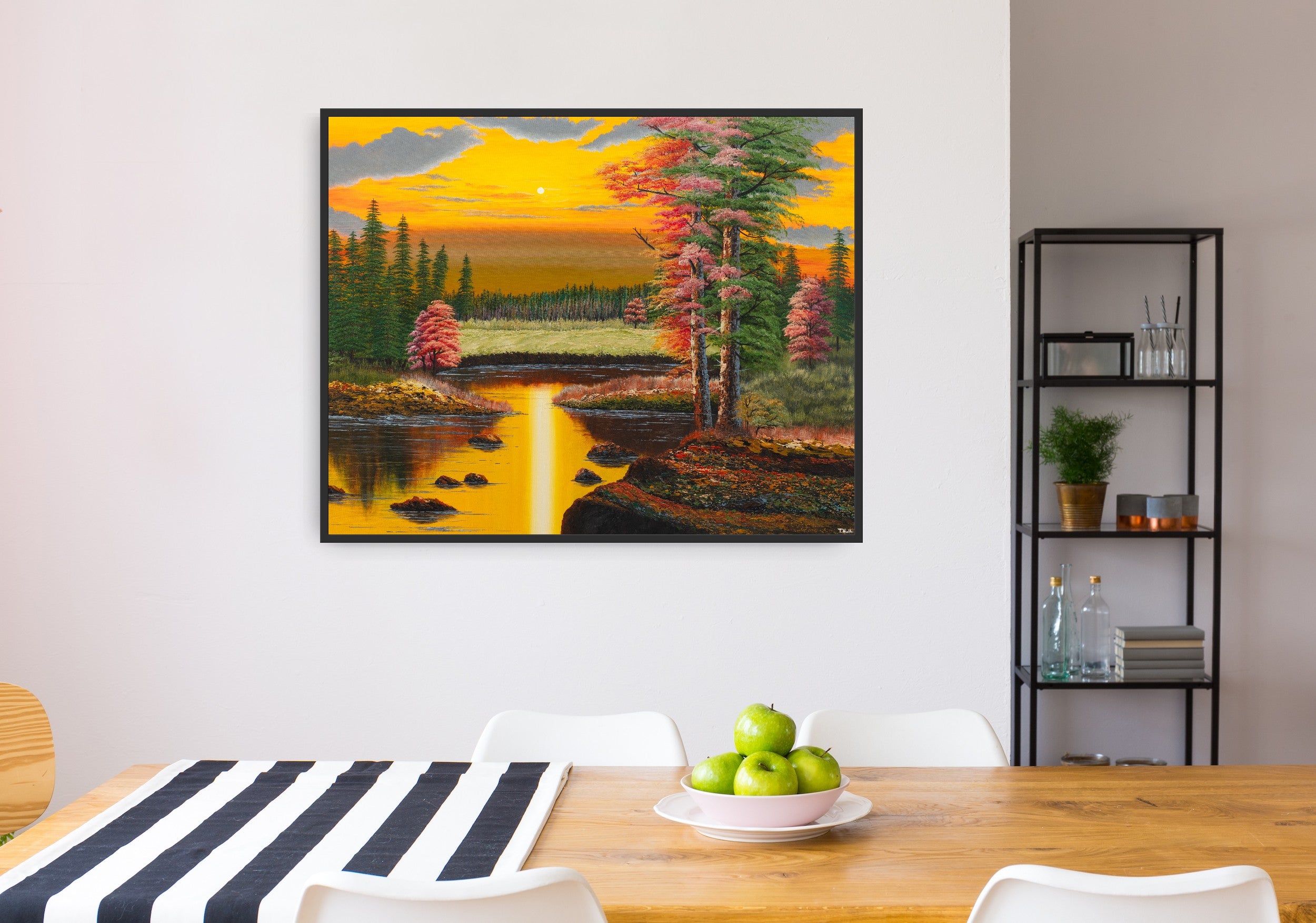 Premium canvas art print showing a warm autumn forest landscape in the yellowish light of a sunset, a big lake and lots of green and red trees, printed on high-quality canvas with vibrant colors, hanging on the wall in a kitchen.