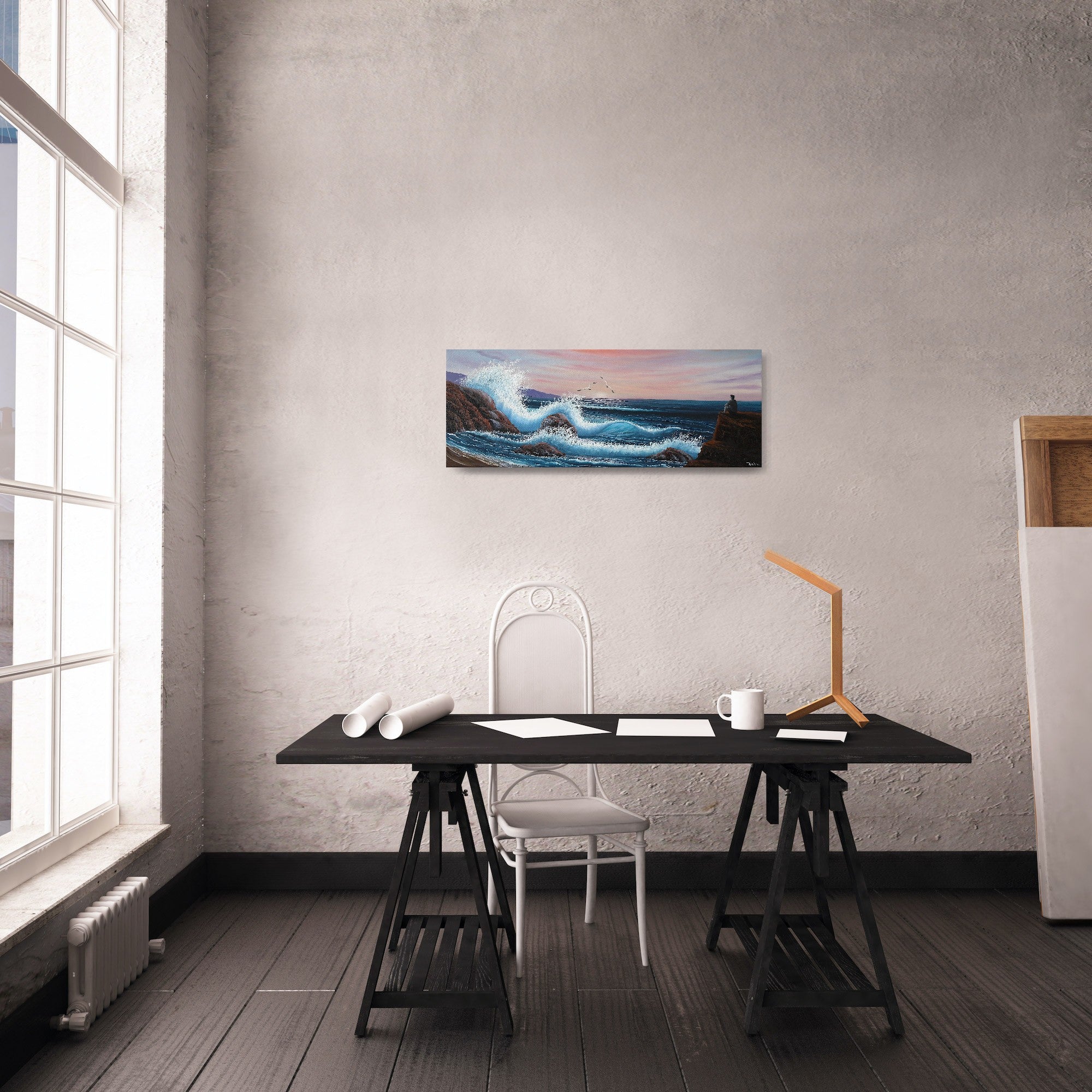Oil painting on canvas showing a dramatic seascape with large blue waves crashing against rocky cliffs at sunset. Pink and purple clouds fill the sky. A grey person sits on a rock, gazing out at the ocean. The painting is shown in a modern office room.