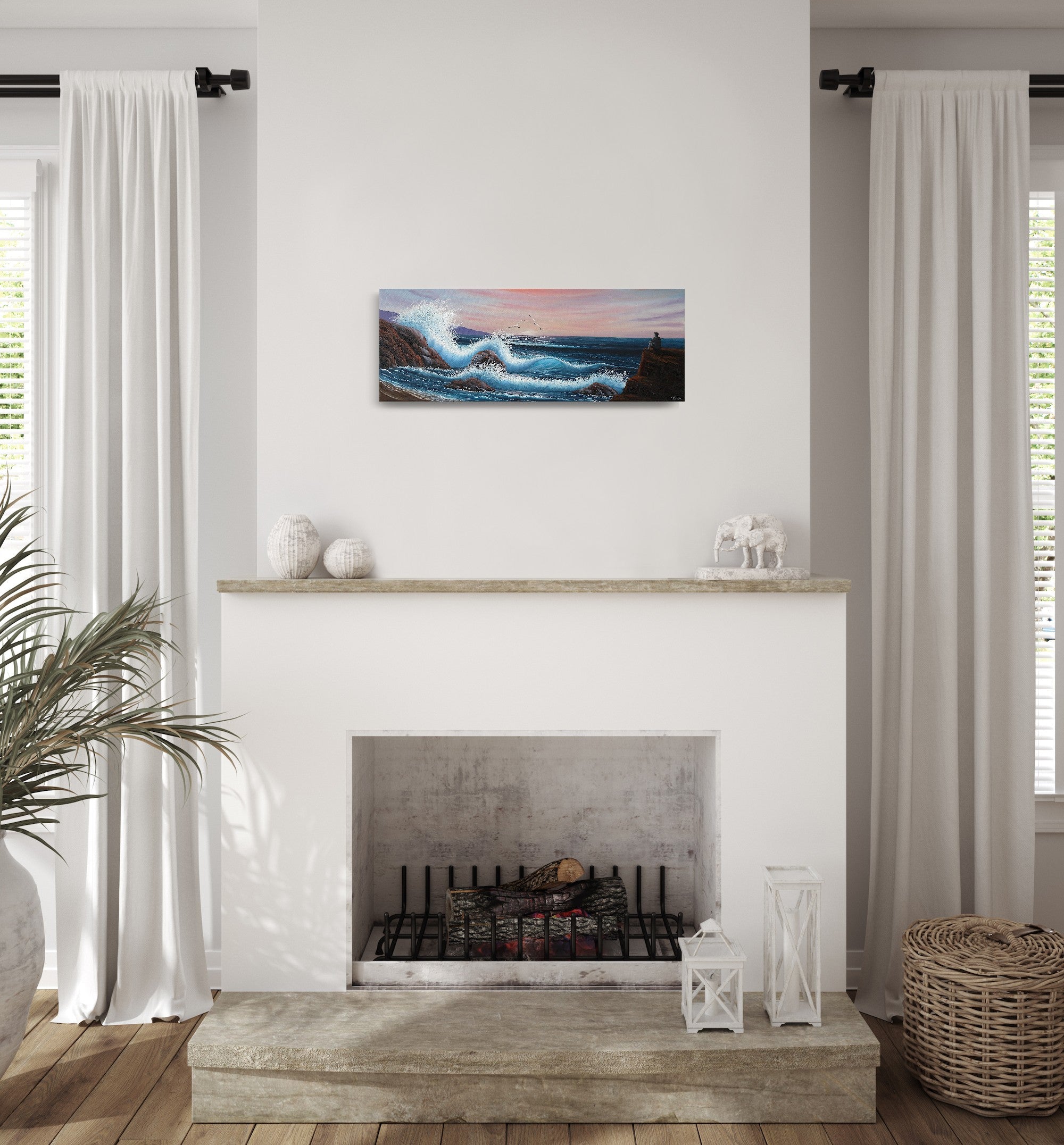 Oil painting on canvas showing a dramatic seascape with large blue waves crashing against rocky cliffs at sunset. Pink and purple clouds fill the sky. A grey person sits on a rock, gazing out at the ocean. The painting is shown on the wall over a fireplace.