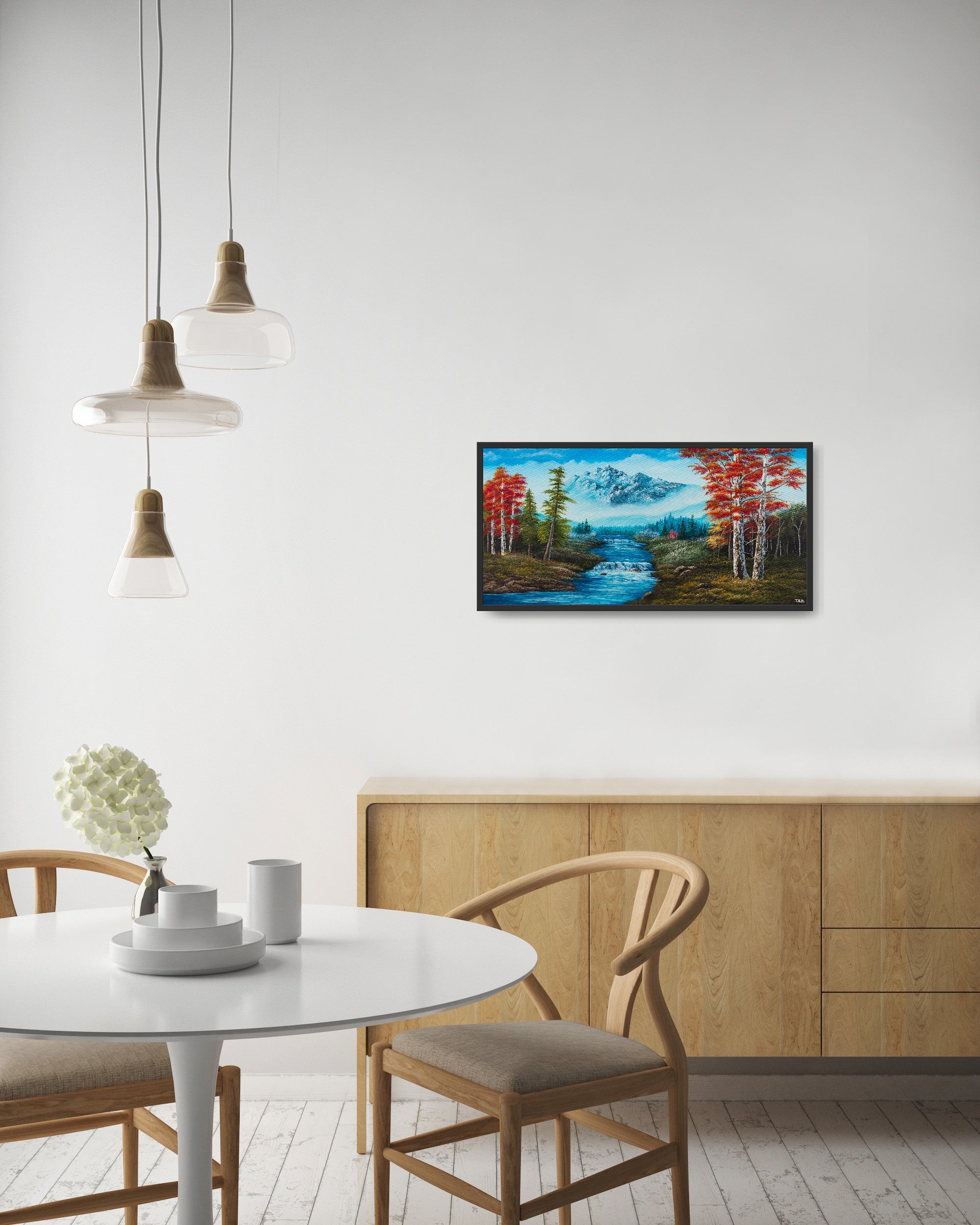 Original artwork by Tobias Nolte titled “Forest Fantasy”. A hand-painted acrylic painting (80x40 cm) featuring a romantic landscape with red leaf trees, many fir trees, a big bluish mountain, and a waterfall, displayed in a modern kitchen.
