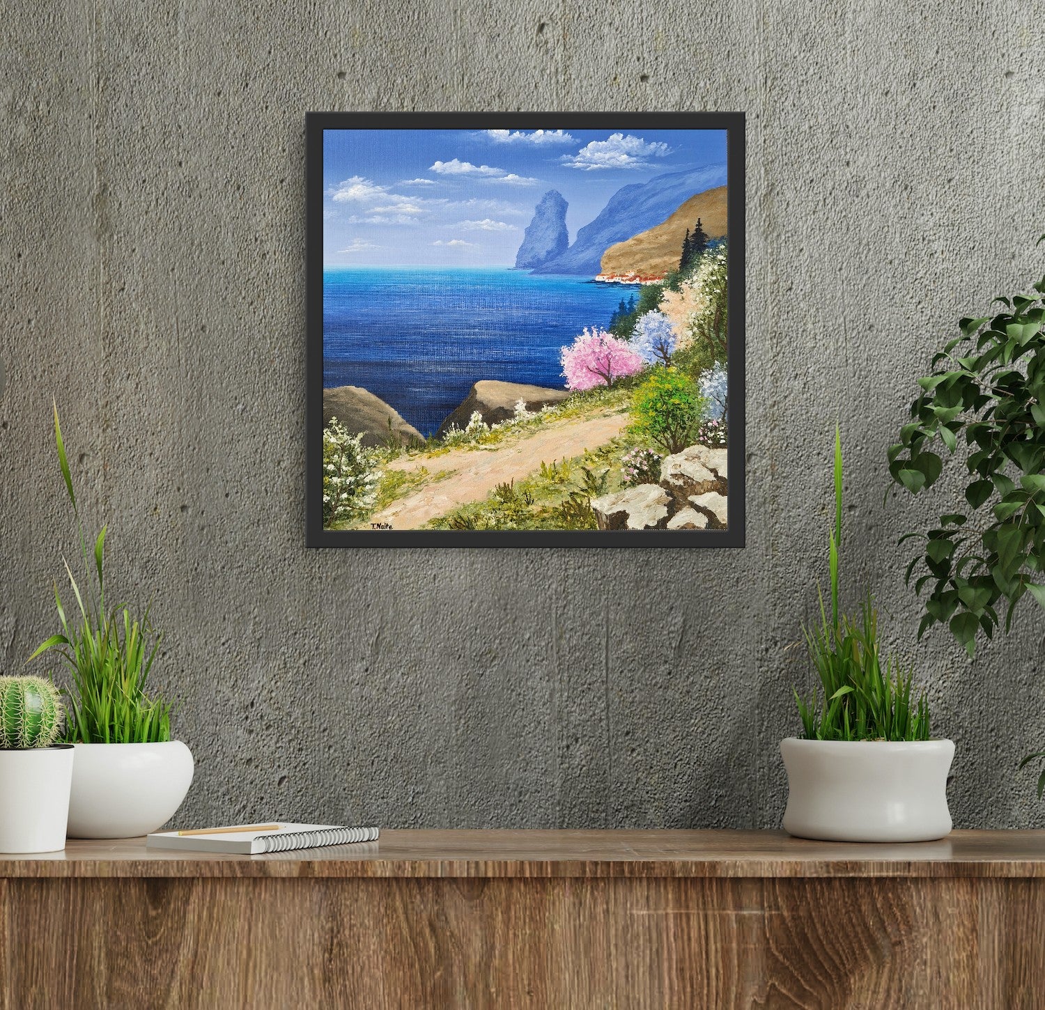 Original artwork by Tobias Nolte titled “Sea View”. A framed, hand-painted oil painting (30x30 cm) featuring a blue sea panorama along a hiking trail, next to colorful trees and rocks, displayed in a modern interior setting.