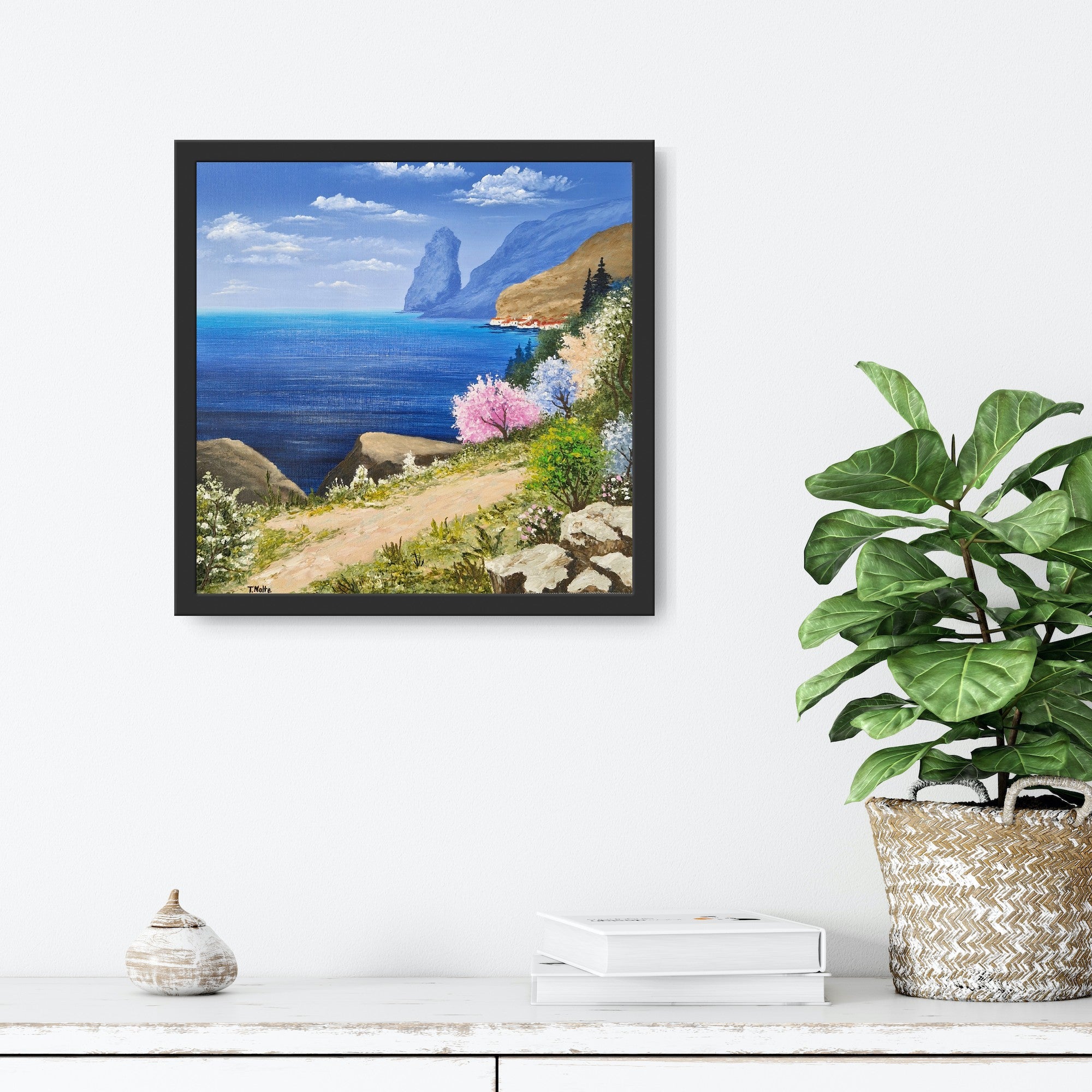 Original artwork by Tobias Nolte titled “Sea View”. A framed, hand-painted oil painting (30x30 cm) featuring a blue sea panorama along a hiking trail, next to colorful trees and rocks, displayed in a modern interior setting.