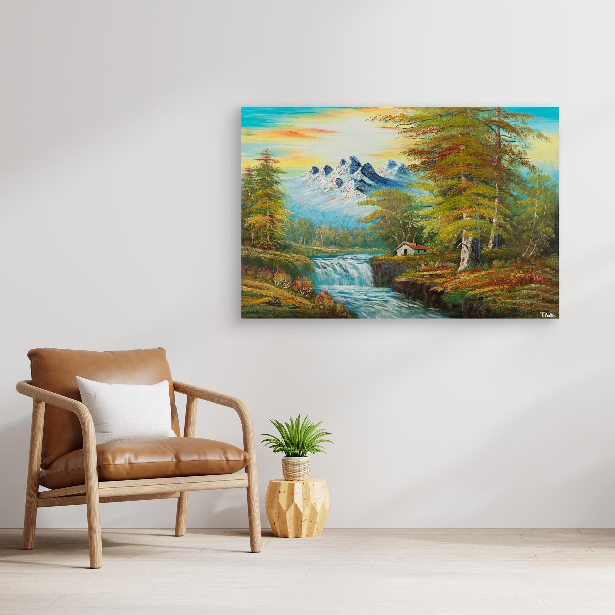 Unframed canvas art print of a calm forest landscape with mountains, a cottage next to a river with some waterfalls and lots of trees and bushes, displayed in a modern living room.